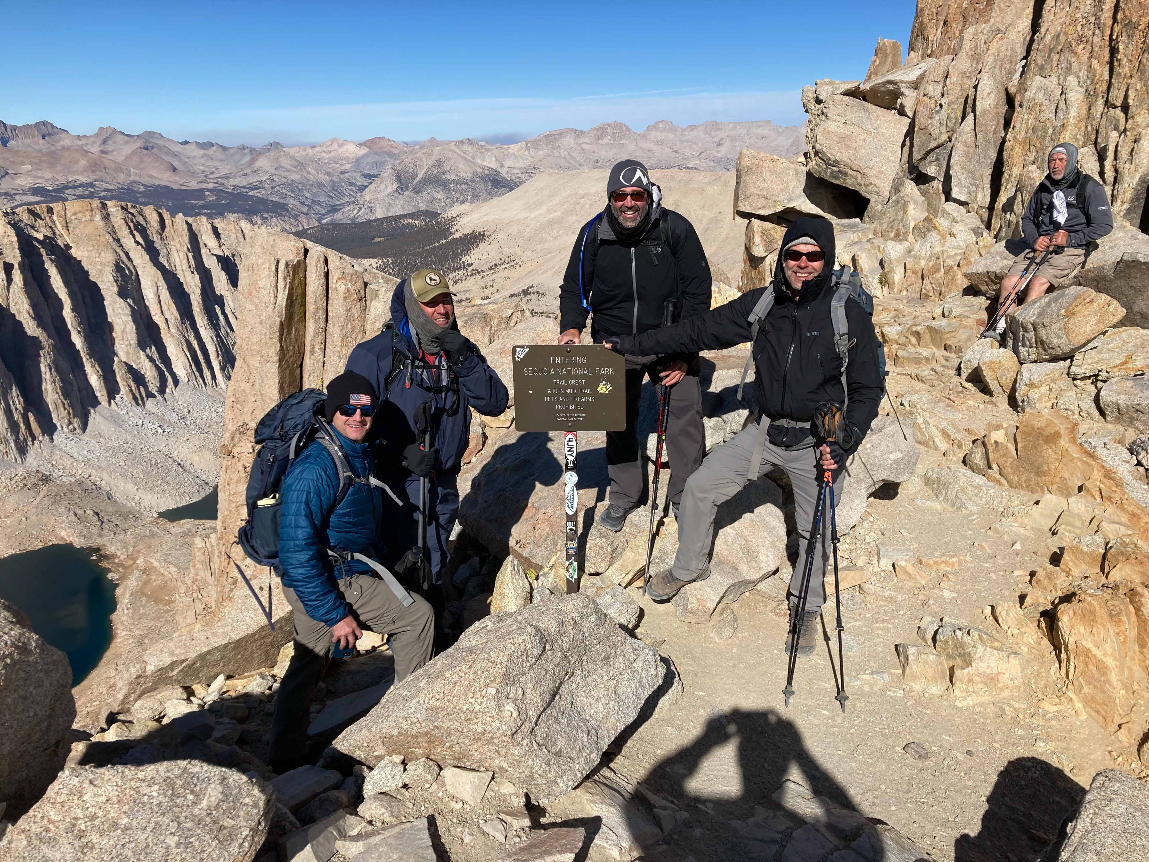 Hikers at the Sequoia National Park boundary sign near the Whitney summit